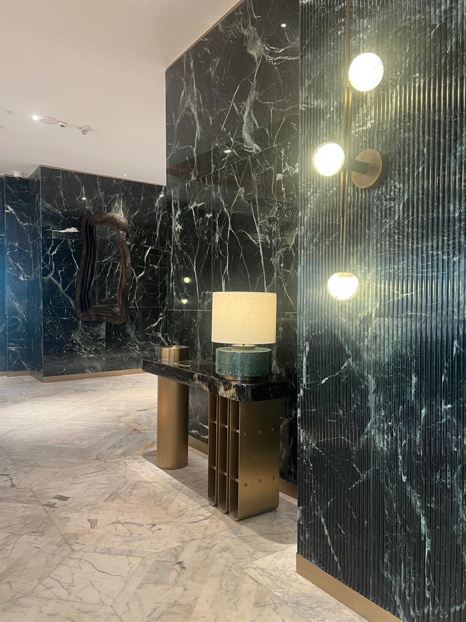 Premium stone wall, fluted finish and decorative lighting detail