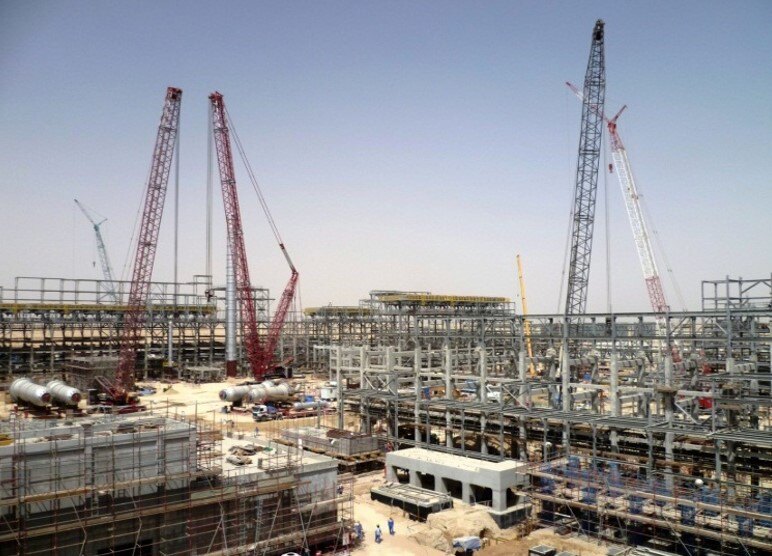 Large industrial process plant under construction with heavy cranes